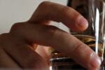 Image of glass of alcohol in man's hand
